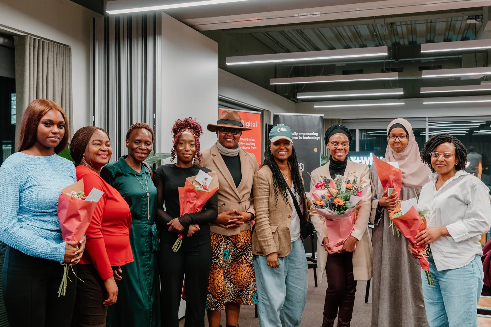 Niyo community members smiling and holding flowers at a celebration event